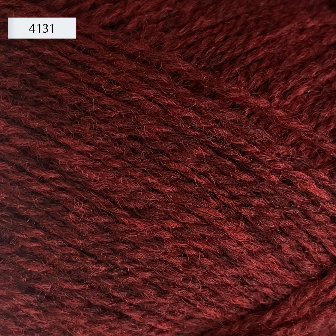 Rauma Finullgarn, a fingering/sport weight yarn, in color 4131, a heathered warm burgundy