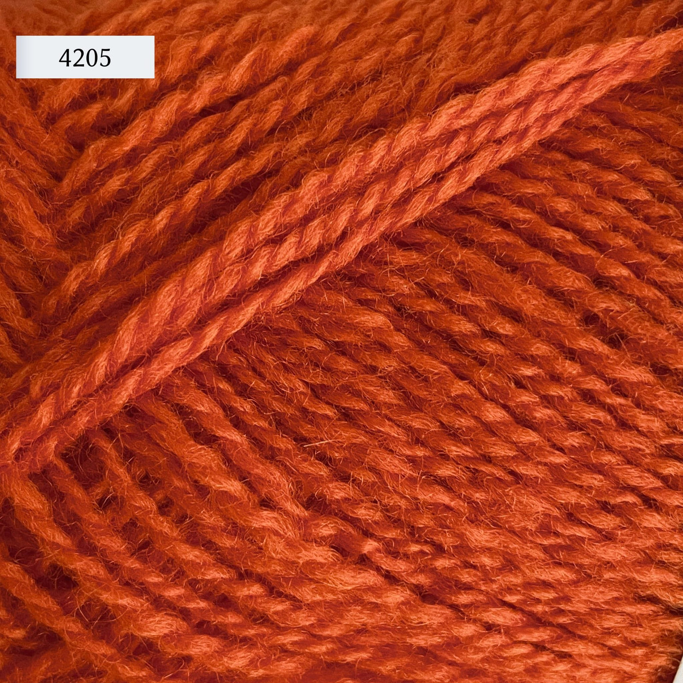 Rauma Finullgarn, a fingering/sport weight yarn, in color 4205, a bright primary orange