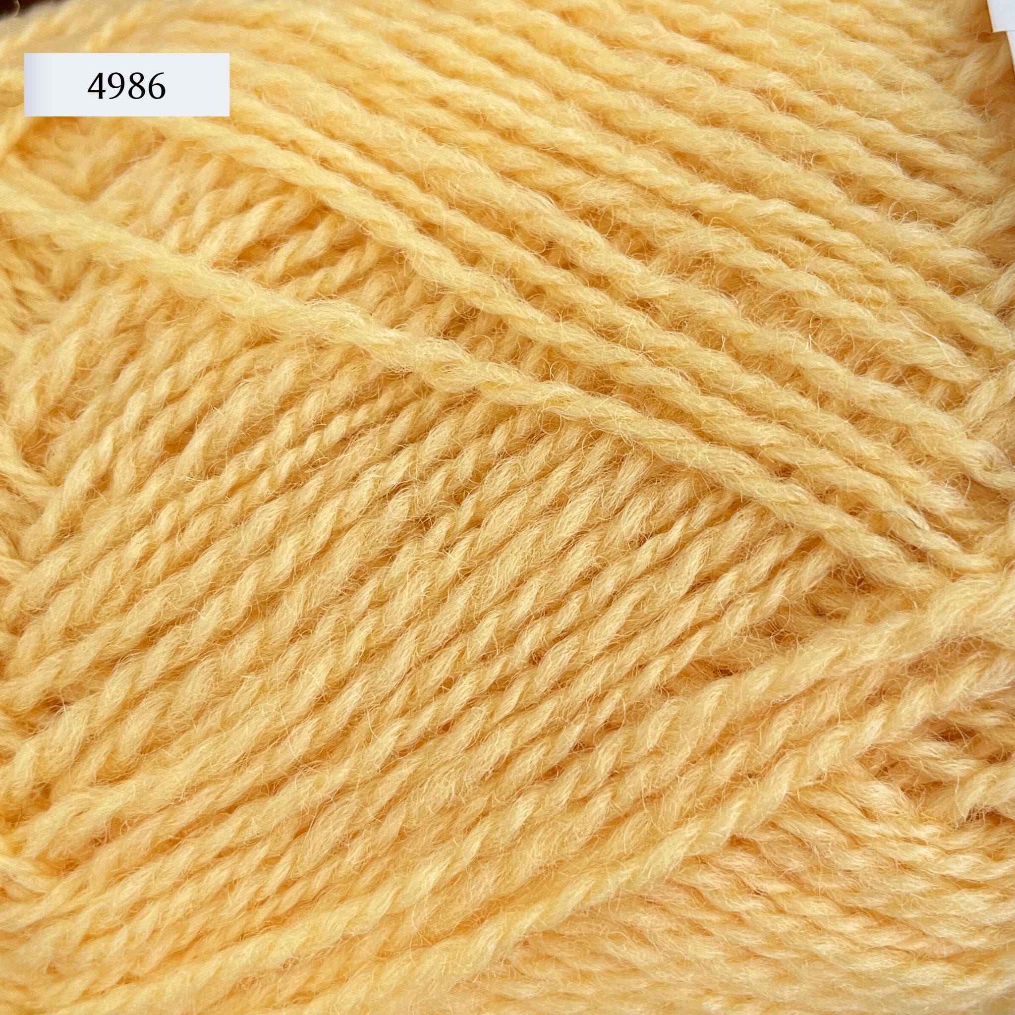 Rauma Finullgarn, a fingering/sport weight yarn, in color 4986, a light butter yellow