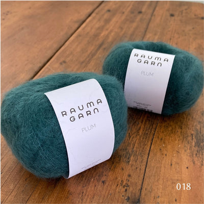 Two balls of Rauma Plum, a laceweight mohair blend yarn, in color 018, petrol blue