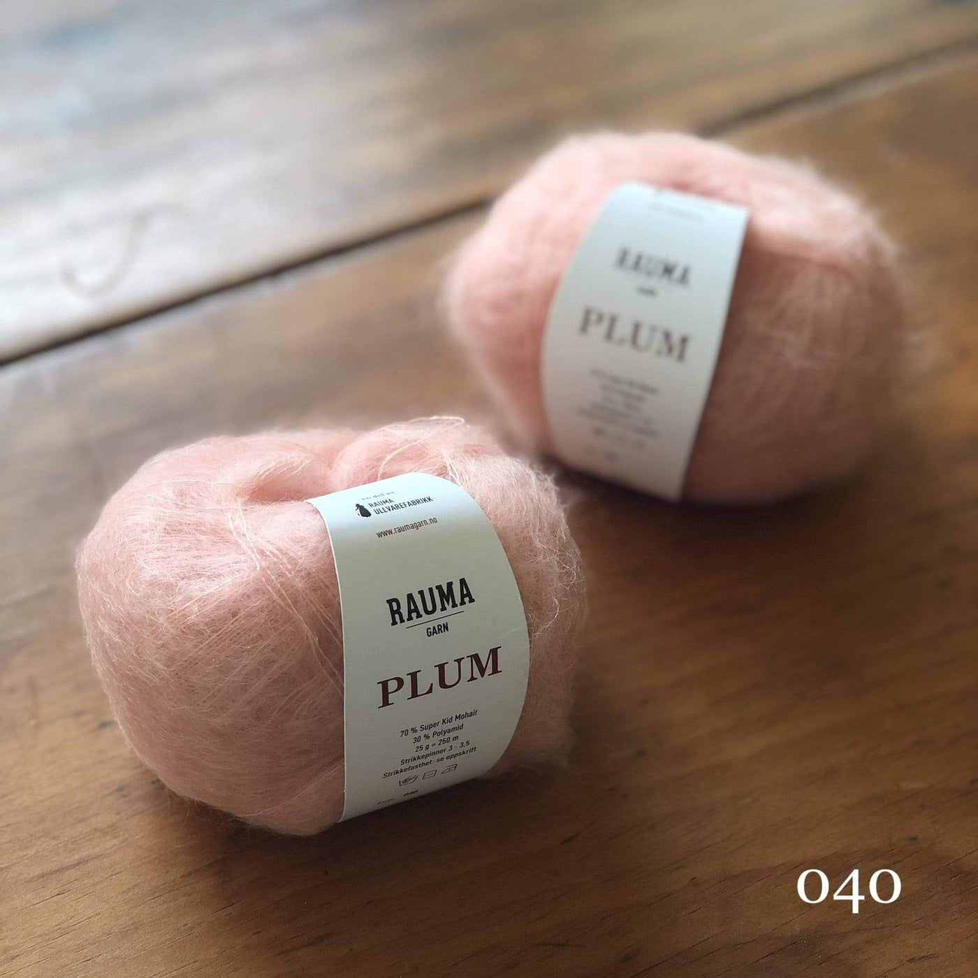 Two balls of Rauma Plum, a laceweight mohair blend yarn, in color 040, a ballet pink