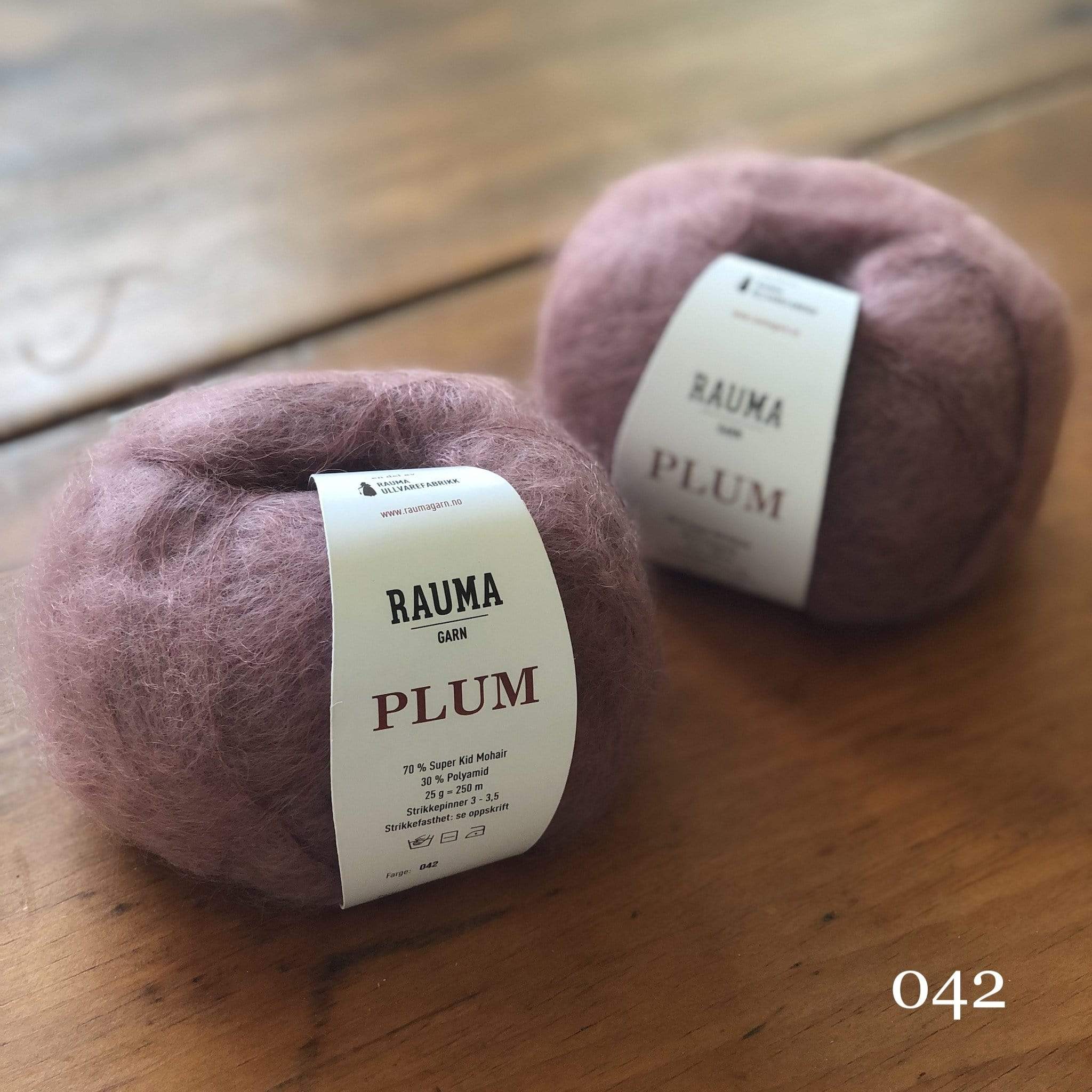 Two balls of Rauma Plum, a laceweight mohair blend yarn, in color 042, a warm mauve purple