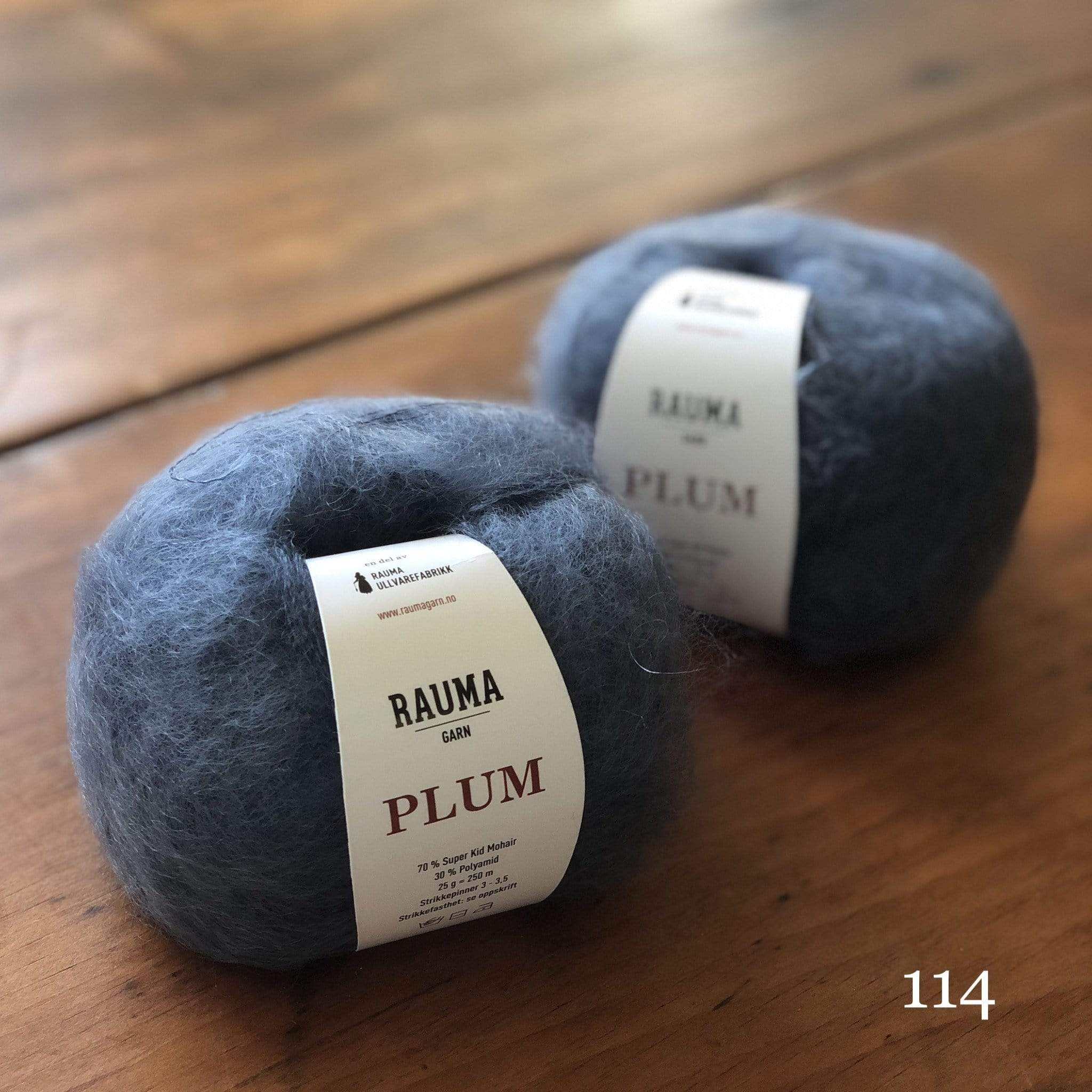 Two balls of Rauma Plum, a laceweight mohair blend yarn, in color 114, medium denim blue