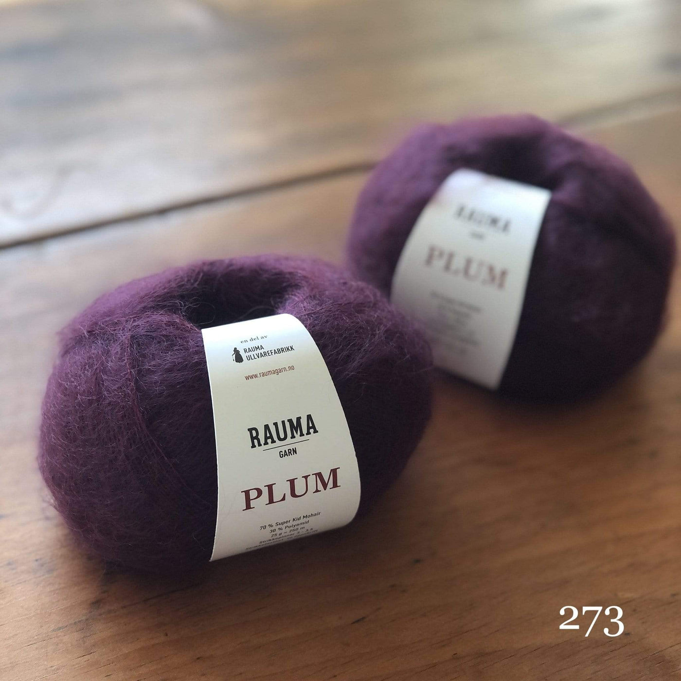 Two balls of Rauma Plum, a laceweight mohair blend yarn, in color 273, a rich plum purple
