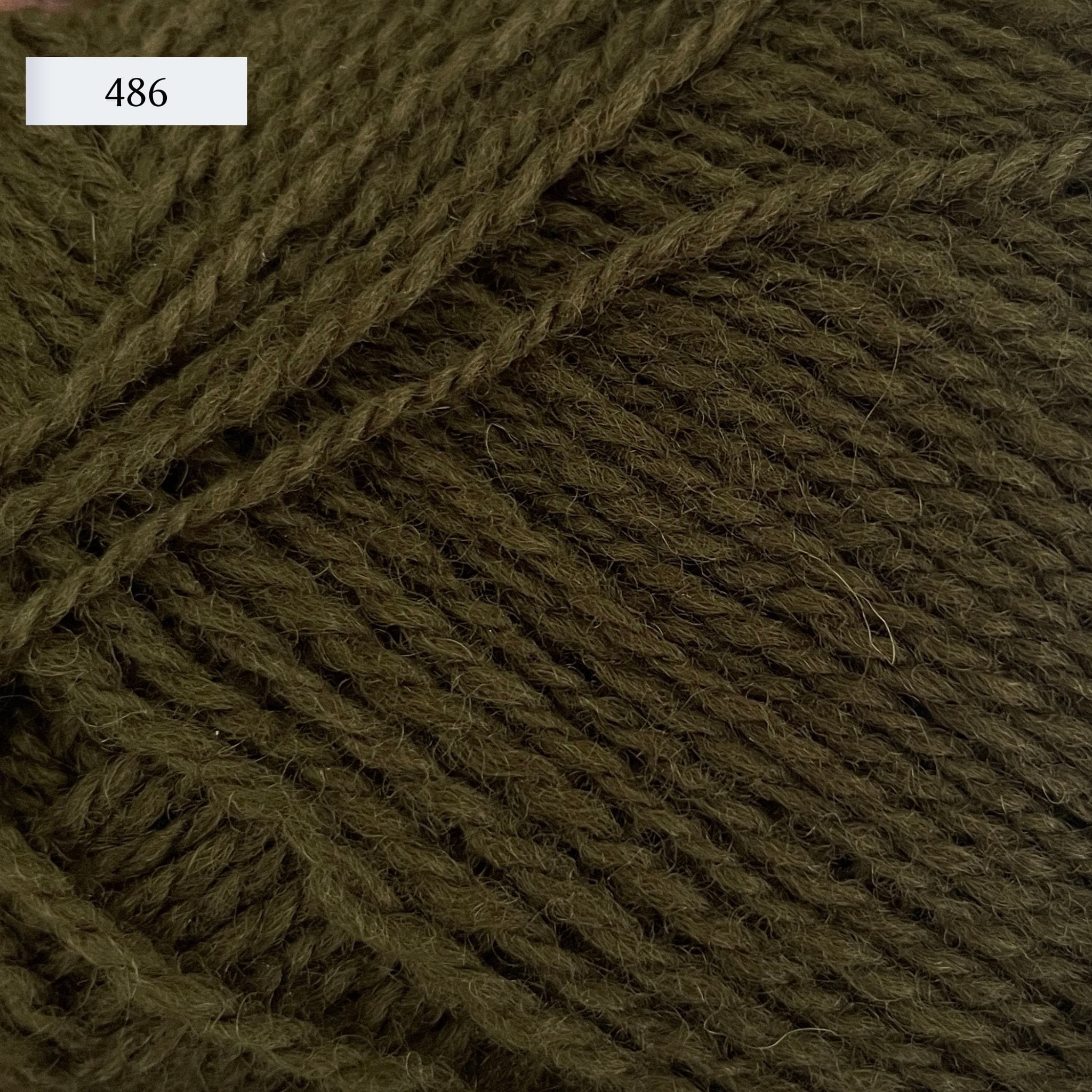 Rauma Finullgarn, a fingering/sport weight yarn, in color 486, a dark army green
