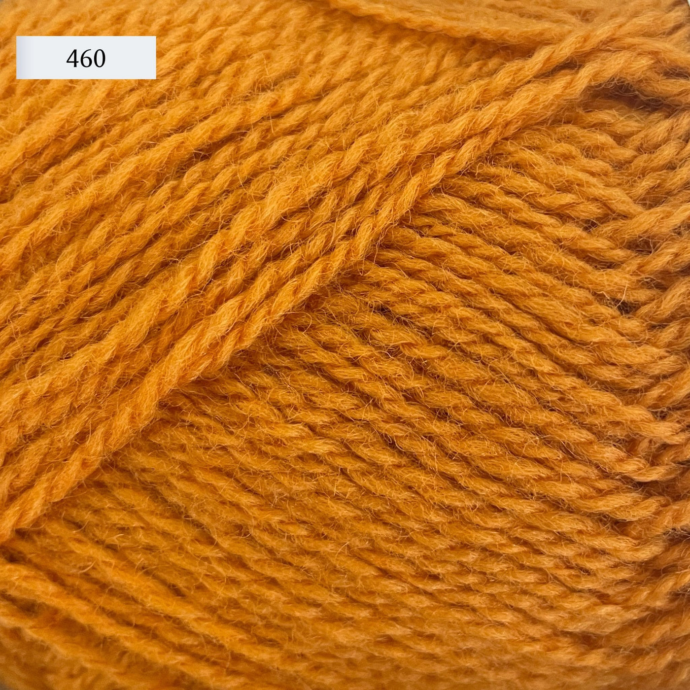 Rauma Finullgarn, a fingering/sport weight yarn, in color 460, a golden orange