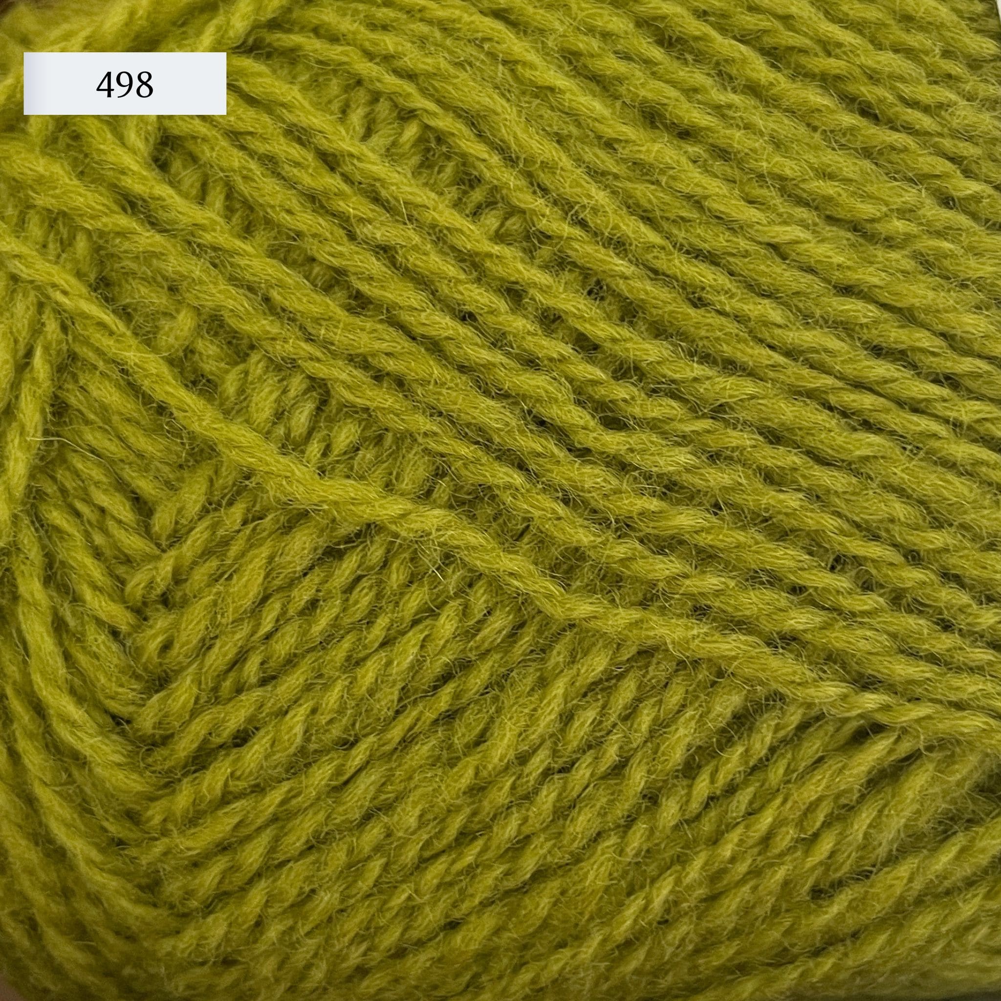Rauma Finullgarn, a fingering/sport weight yarn, in color 498, a light frog green