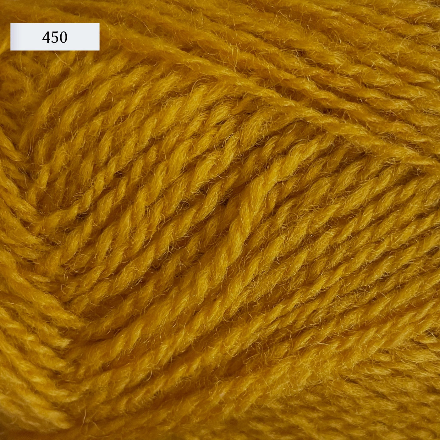 Rauma Finullgarn, a fingering/sport weight yarn, in color 450, a golden yellow