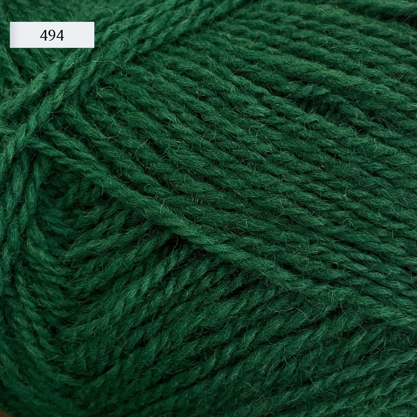 Rauma Finullgarn, a fingering/sport weight yarn, in color 494, a blue-leaning forest green