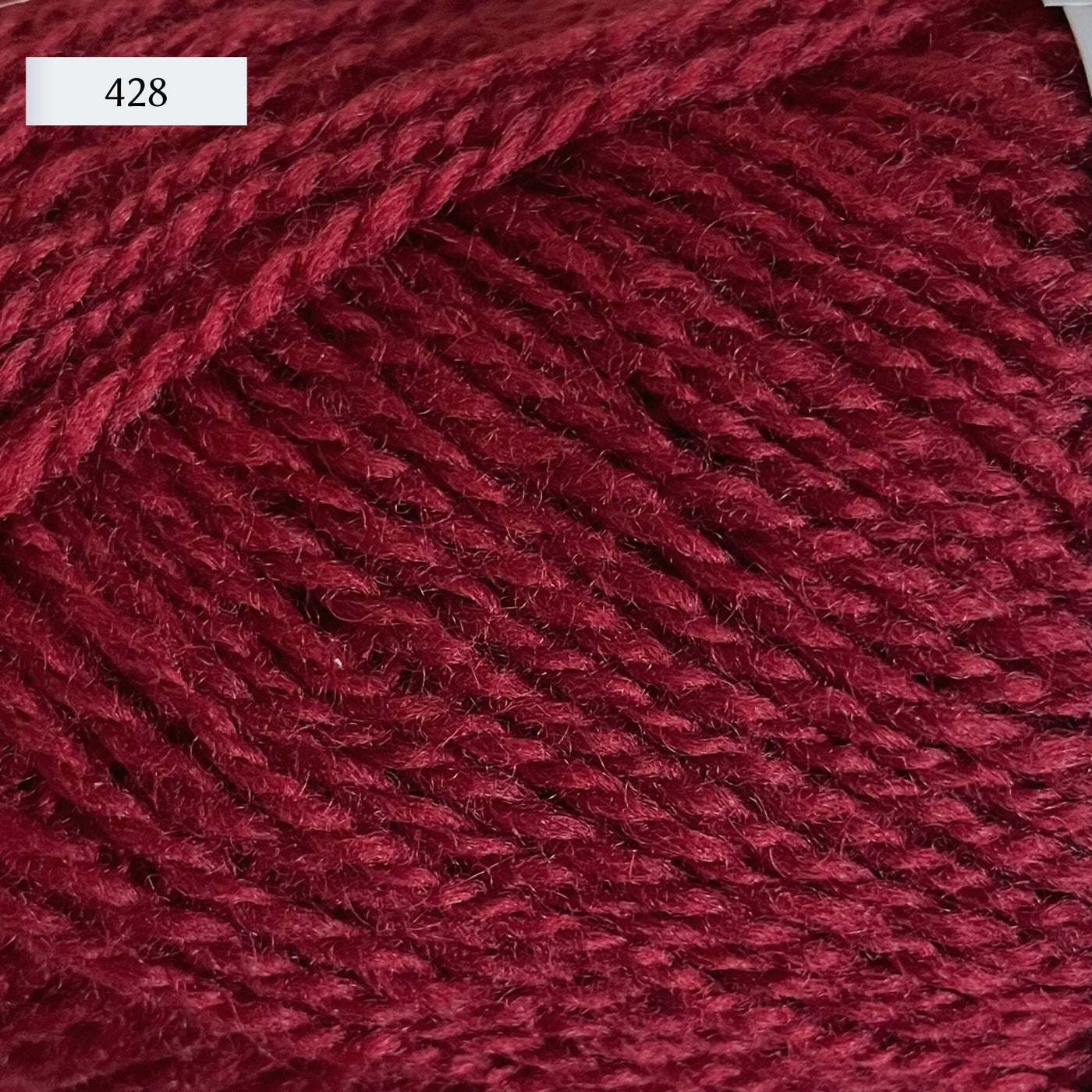 Rauma Finullgarn, a fingering/sport weight yarn, in color 428, a raspberry red