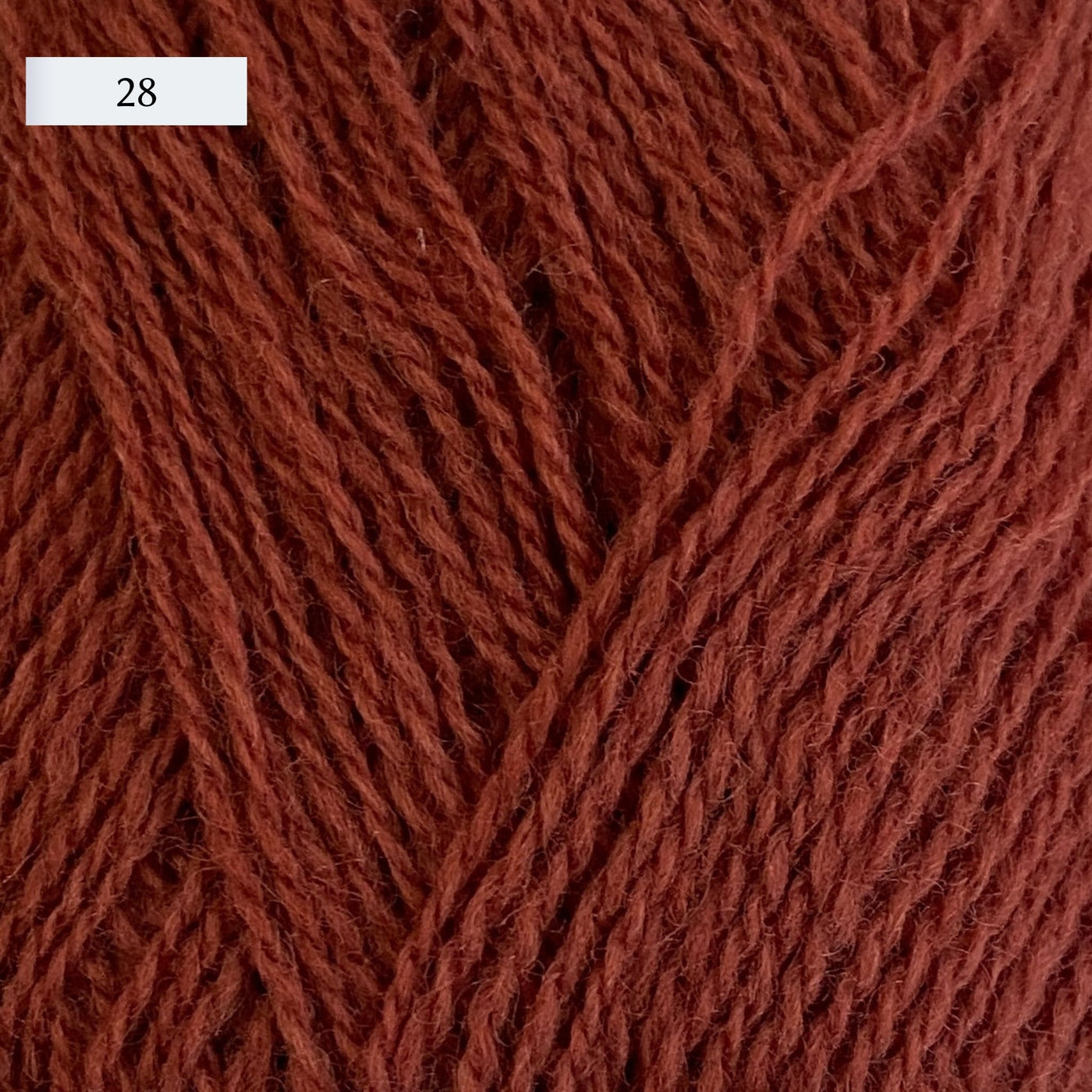 Rauma Lamullgarn, a fingering weight yarn, in color 28, a medium russet red