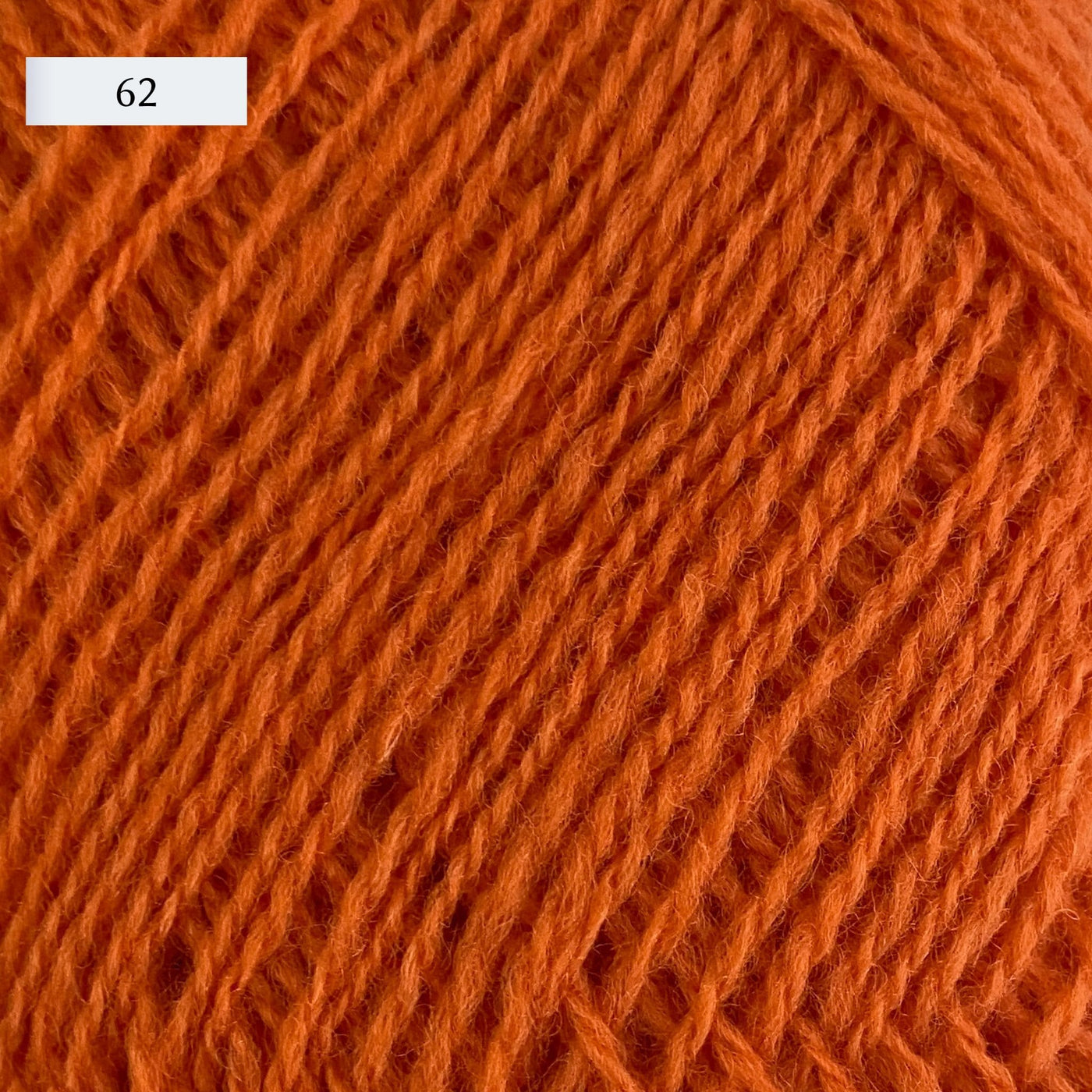 Rauma Lamullgarn, a fingering weight yarn, in color 62, a bright pumpkin orange