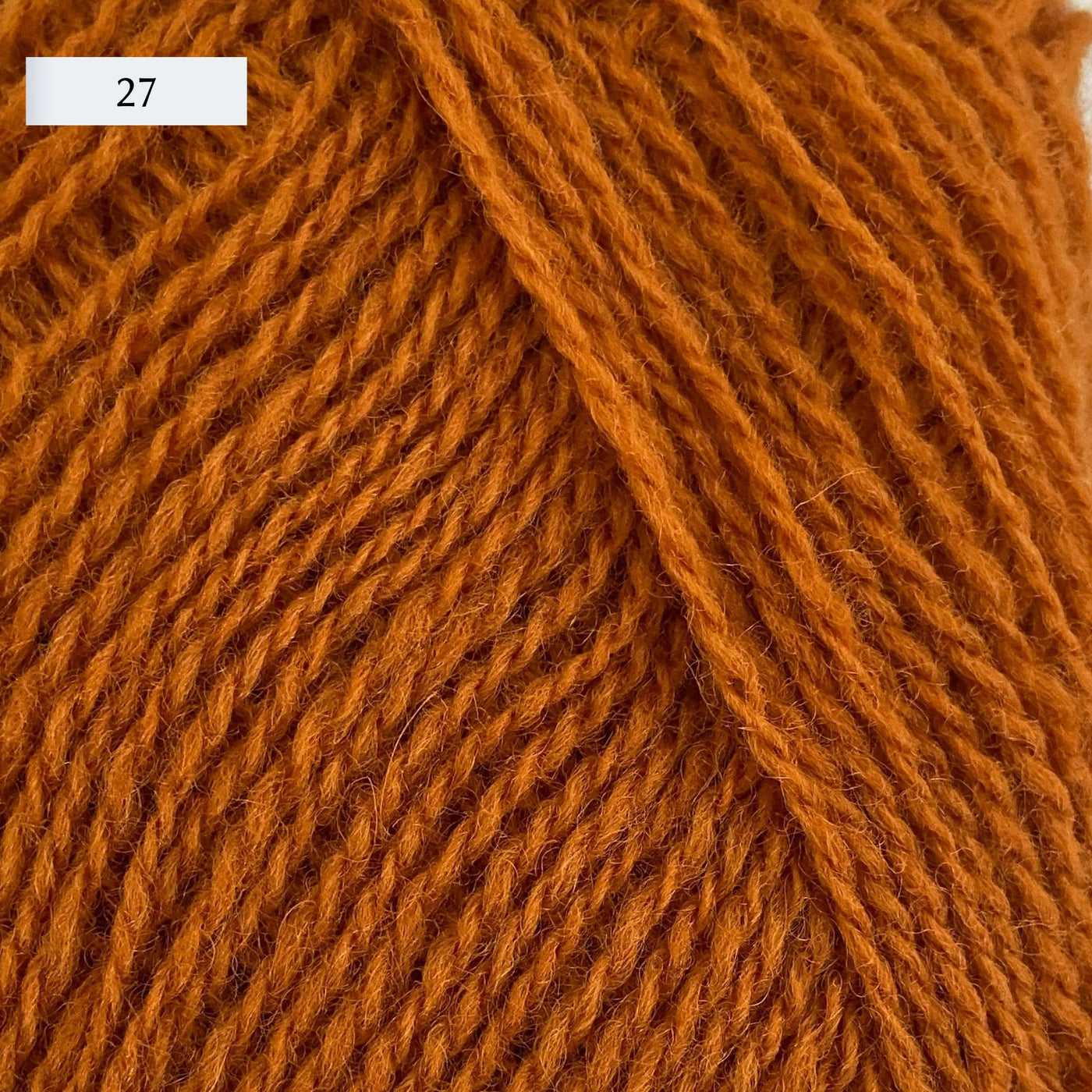 Rauma Lamullgarn, a fingering weight yarn, in color 27, a medium burnt orange