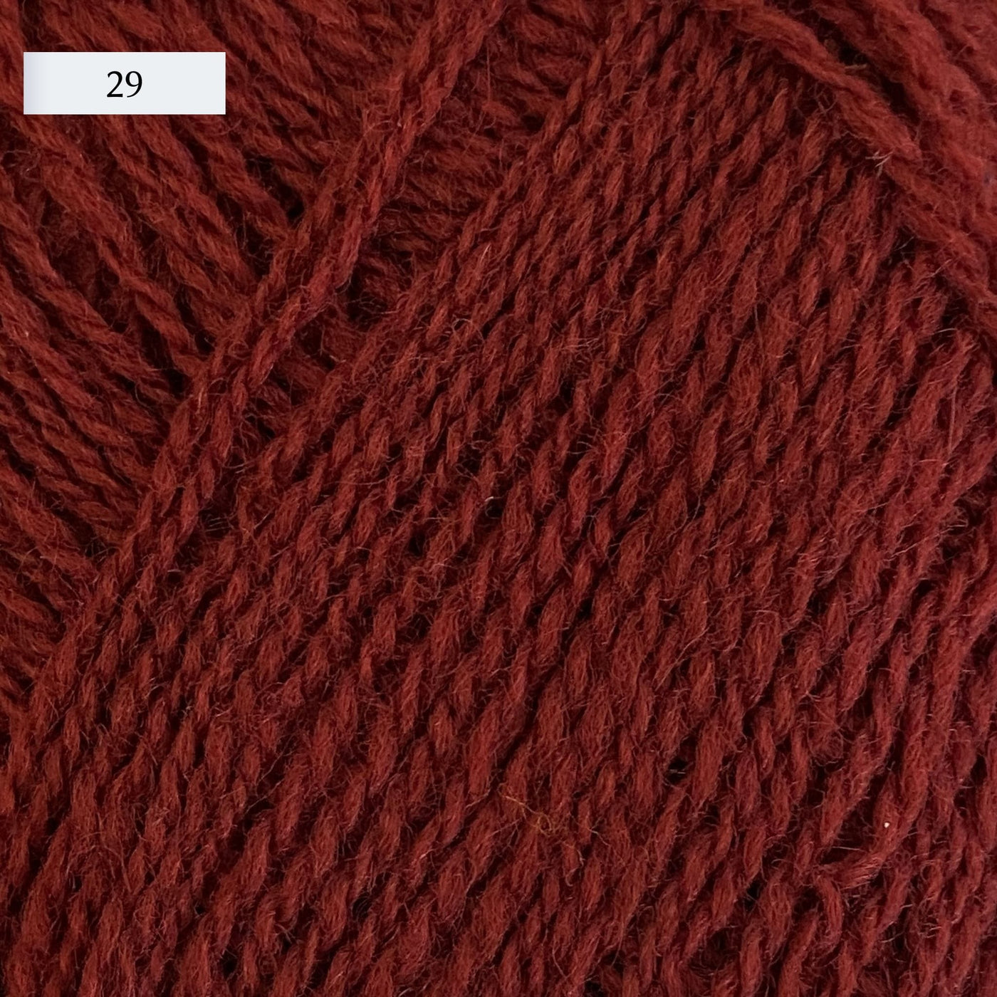 Rauma Lamullgarn, a fingering weight yarn, in color 29, a medium brick red