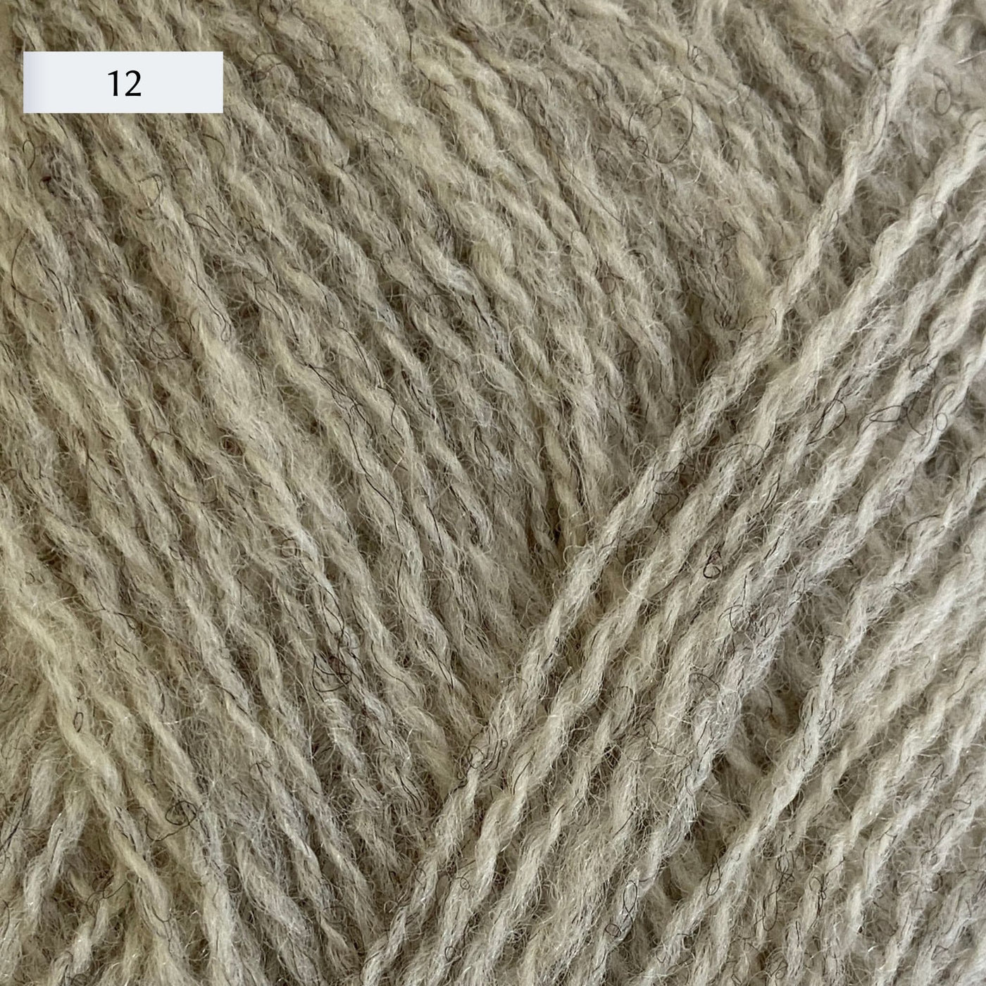 Rauma Lamullgarn, a fingering weight yarn, in color 12, a very light heathered tan/grey