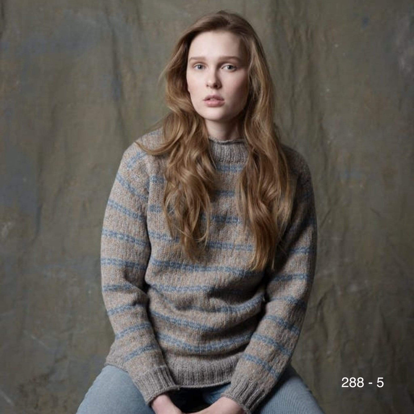 A woman wearing an overall colorwork pullover knit in Rauma Strikkegarn. Pattern 288-5 from Rauma.