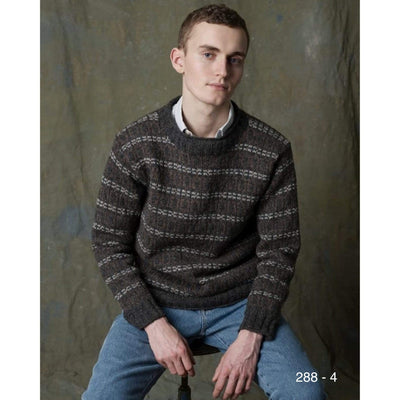 A man wearing Rauma pattern 288-4 which is an overall colorwork pullover knit in Rauma Strikkegarn.