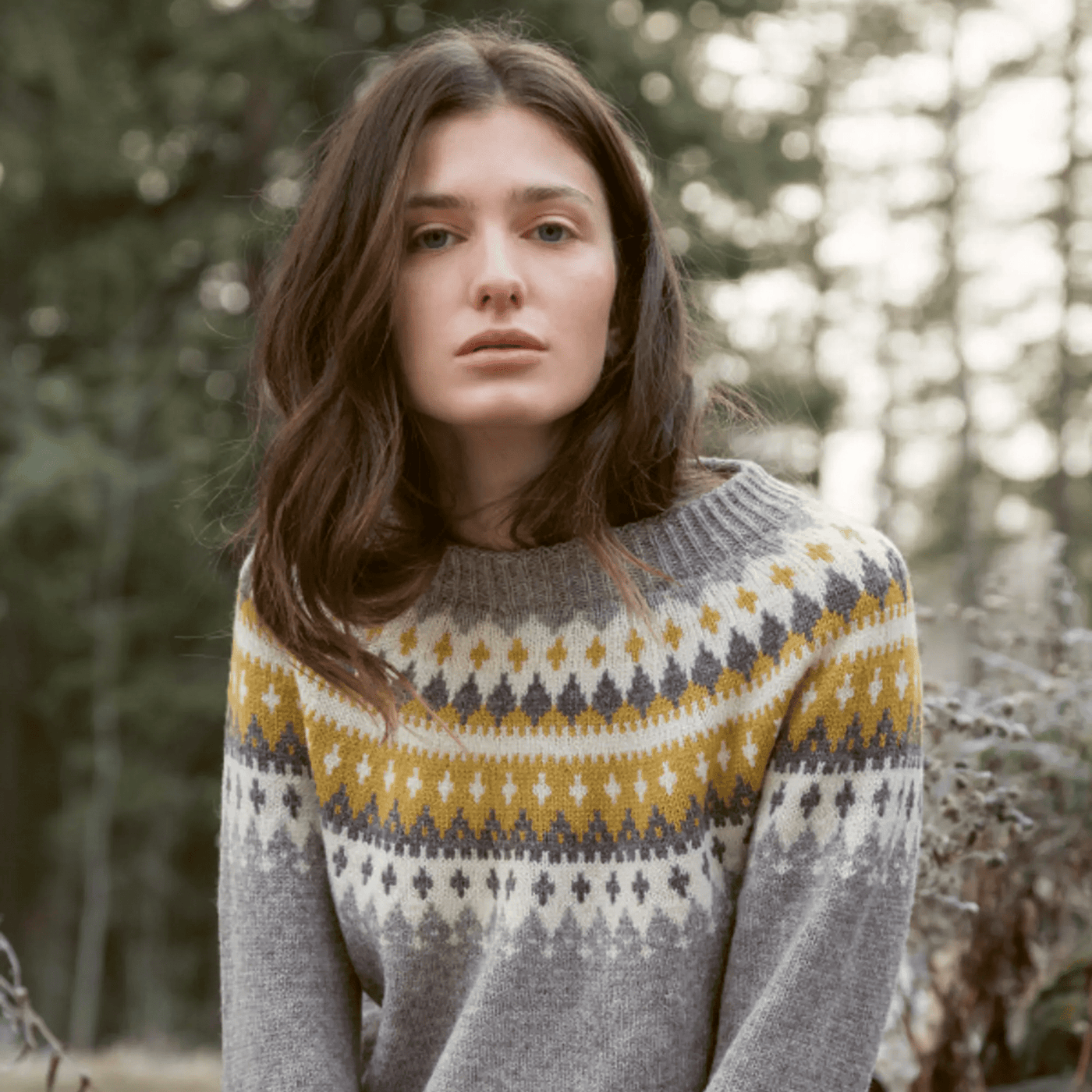 The Woolly Thistle Varde Yoke Sweater 275R in Rauma Finullgarn sweater in grey and pattern with yellow, white, and dark grey
