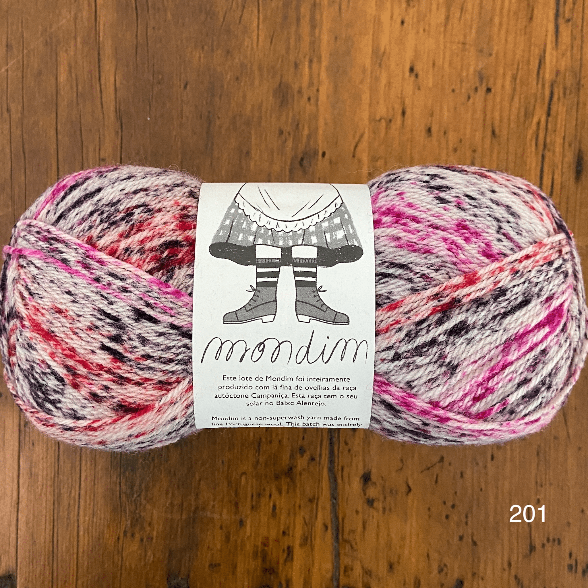 The Woolly Thistle Retrosaria Mondim Fingering Weight Yarn in 201 (mix of black, cream, pink, and red)