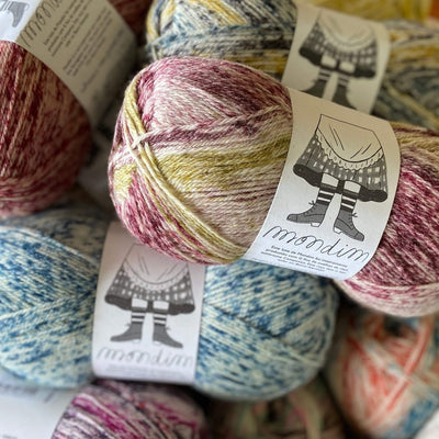 The Woolly Thistle Retrosaria Mondim Fingering Weight Yarn in multi-colors like blue/cream, pink/cream, yellow/cream, and more