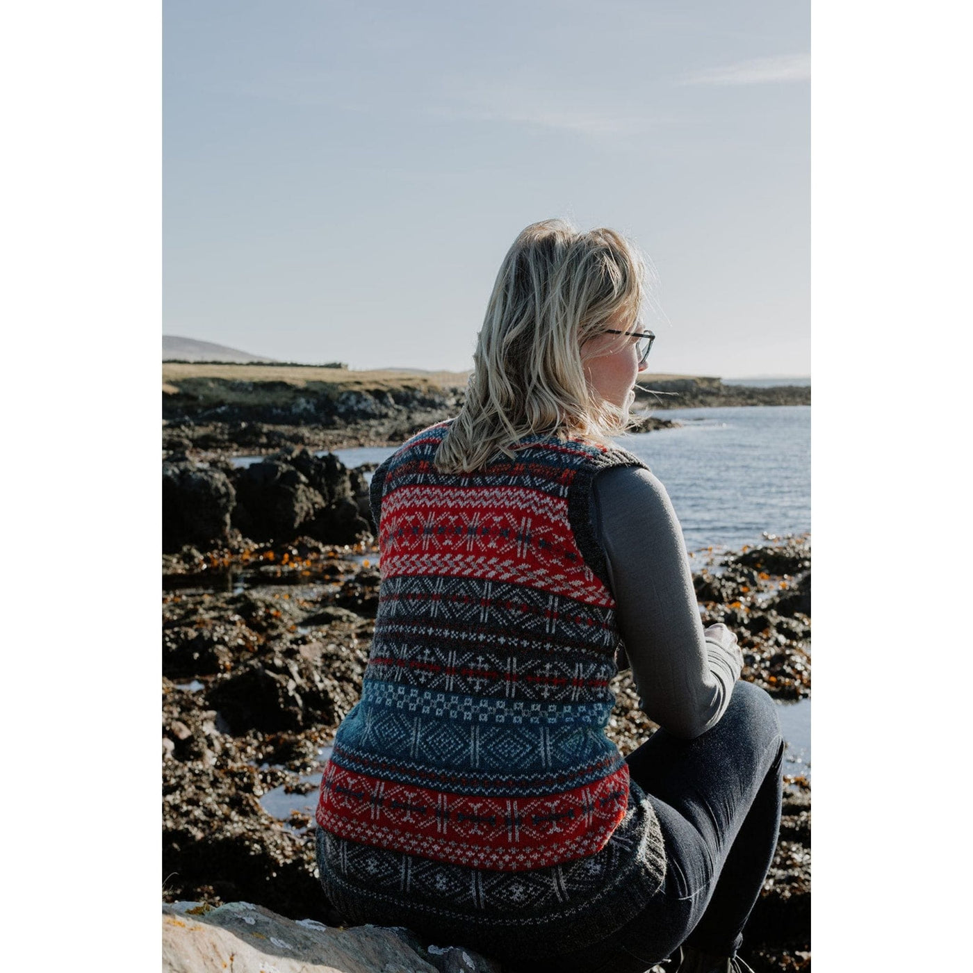 Page of Shetland Wool Adventure Journal 4, showing back view of woman wearing colorwork sleeveless sweater which is a pattern in the book.