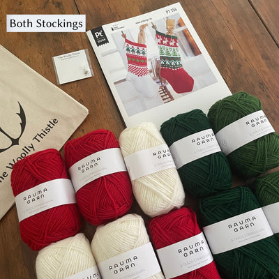 Christmas Stocking Yarn Kit components to make 2 different variations of Stockings. arranged on wooden table. 10 balls of Strikkegarn yarn in red, greens, and white with pattern card and The Woolly Thistle tote and stitch marker. 
