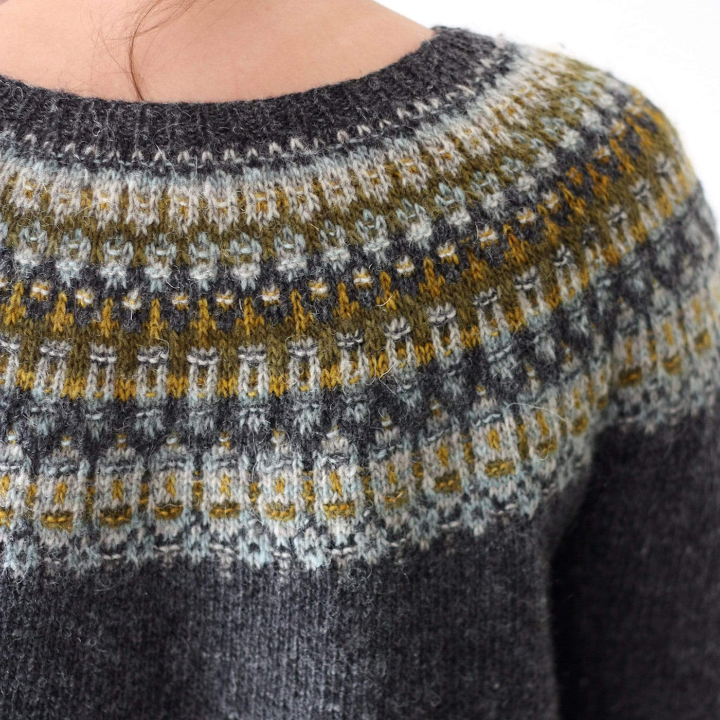 Shown close up of colorwork on model, the Lunenburg Pullover by Amy Christoffers, knit in Lichen and Lace Rustic Sport weight yarn. 