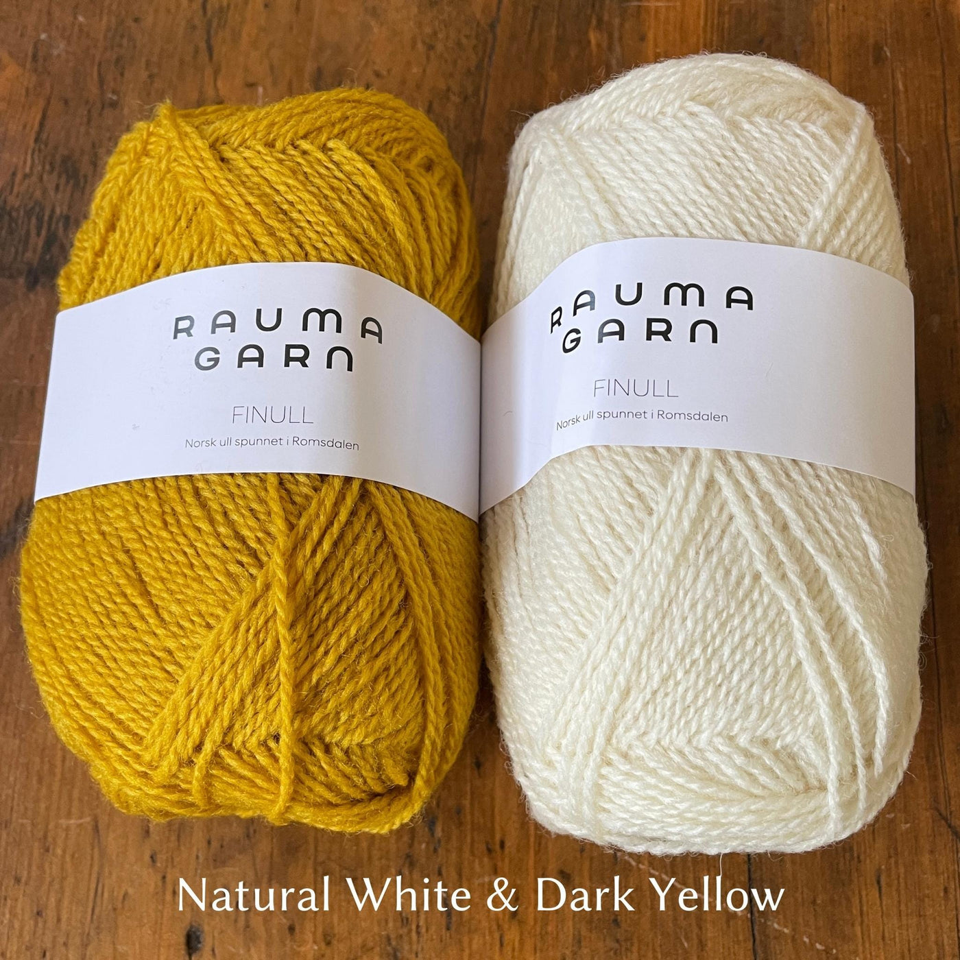 Two balls of Finullgarn yarn; one dark yellow, one natural white color