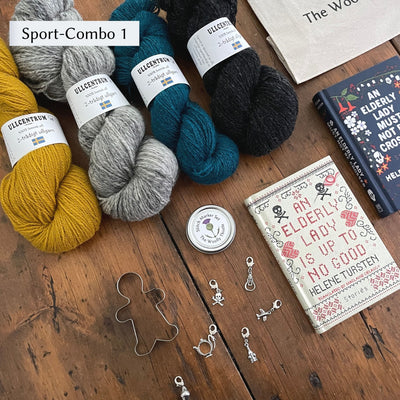 The Swedish Book Bundle components which include two books by Helene Tursten, TWT Tote bag, Stitch marker set, gingerbread cookie cutter, and Ullcentrum Sport Weight yarn. Components are shown and laid out on table. Yarn colors in Sport Combo 1 include gold, grey, dark teal, and dark grey.