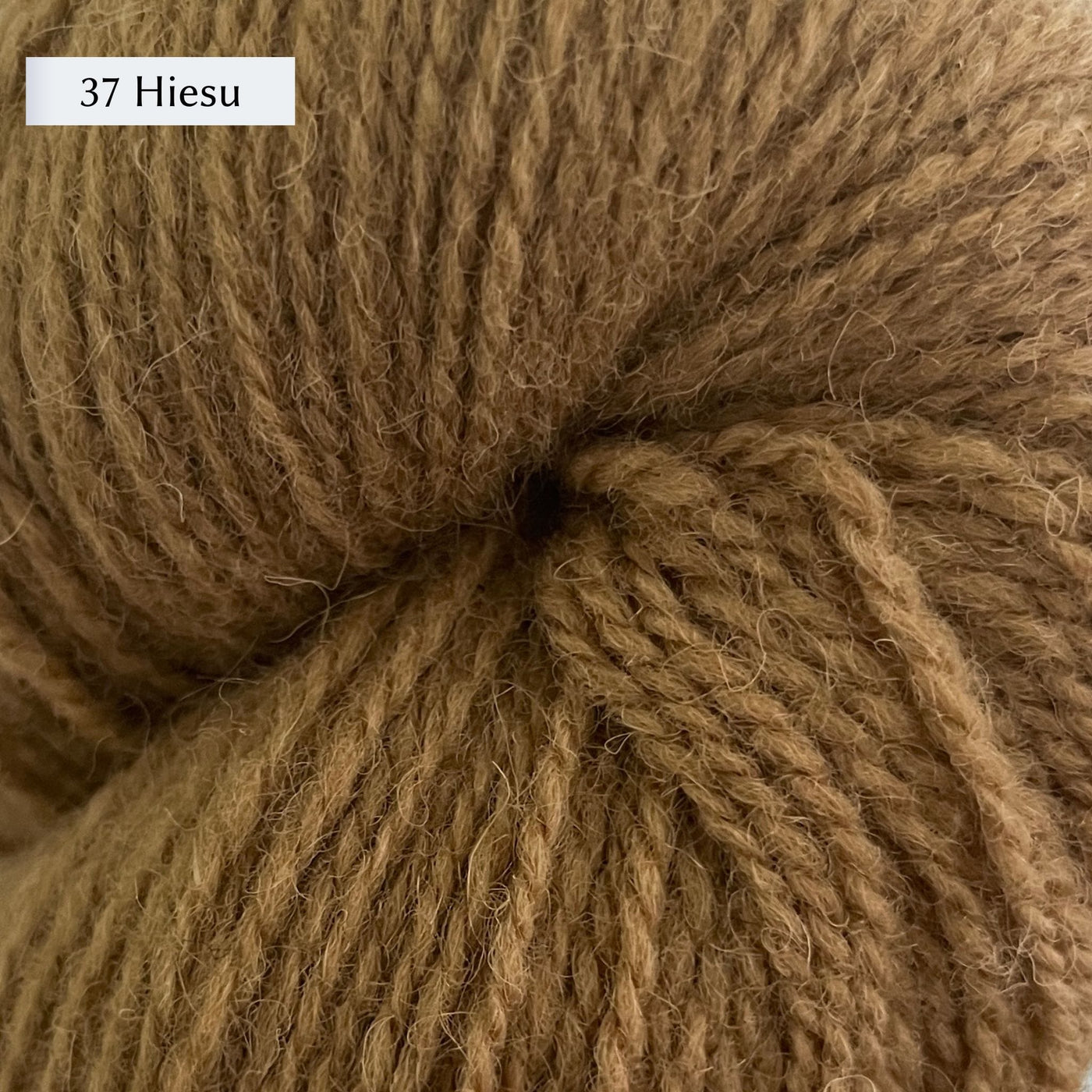 Tukuwool DK Yarn, 100% Finnish Wool shown in colorway 37 Heisu which is a tan/yellow color. 