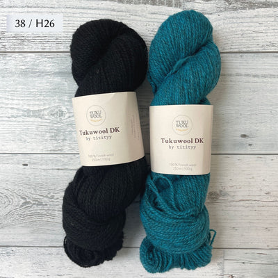 Two Skeins of Tukuwool DK shown as a colorway option for the Muisto Hat & Mittens Set. 38 (black) and H26 (heathered turquoise.)
