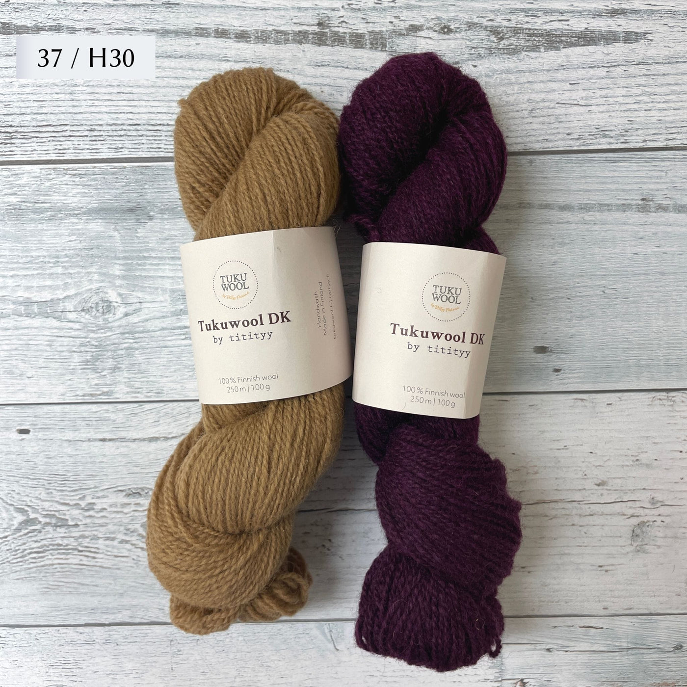 Two Skeins of Tukuwool DK shown as a colorway option for the Muisto Hat & Mittens Set. 37 (tan) and H30 (heathered deep purple.)