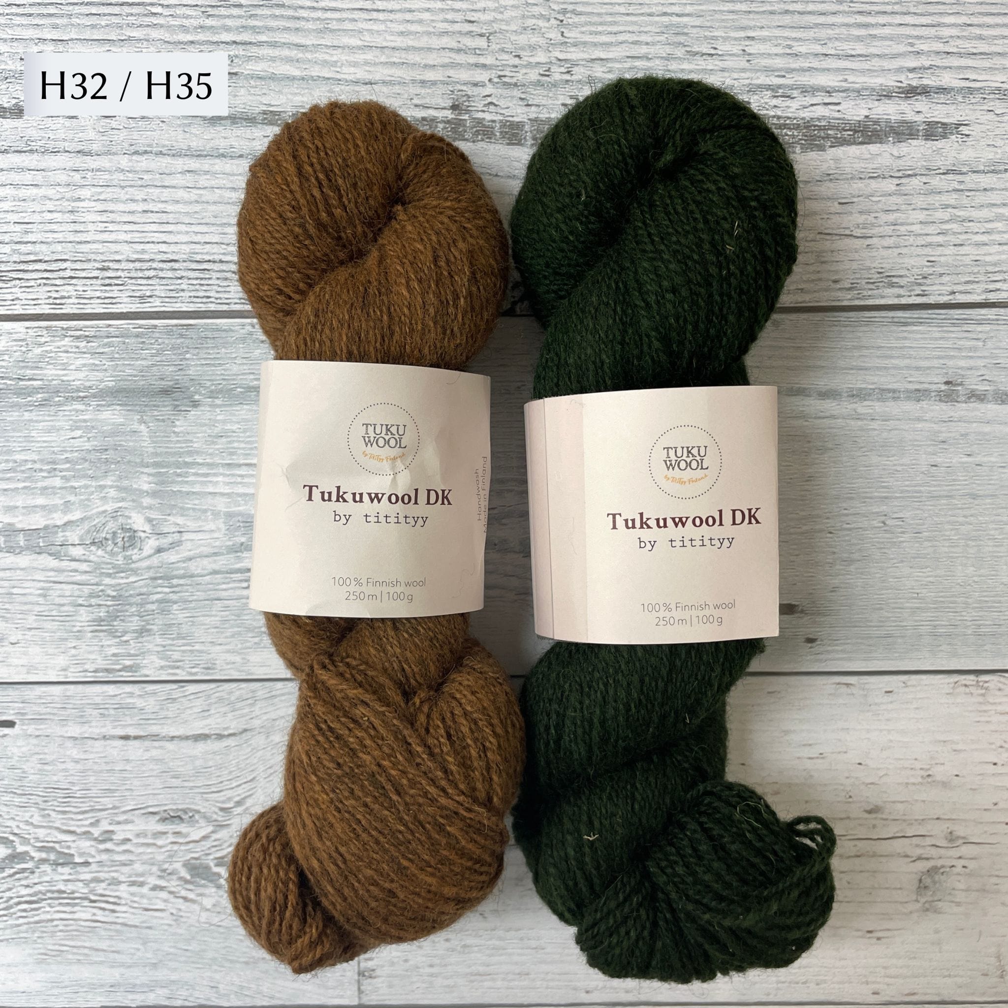 Two Skeins of Tukuwool DK shown as a colorway option for the Muisto Hat & Mittens Set. H32 (heathered gold) and H35 (heathered deep green.)