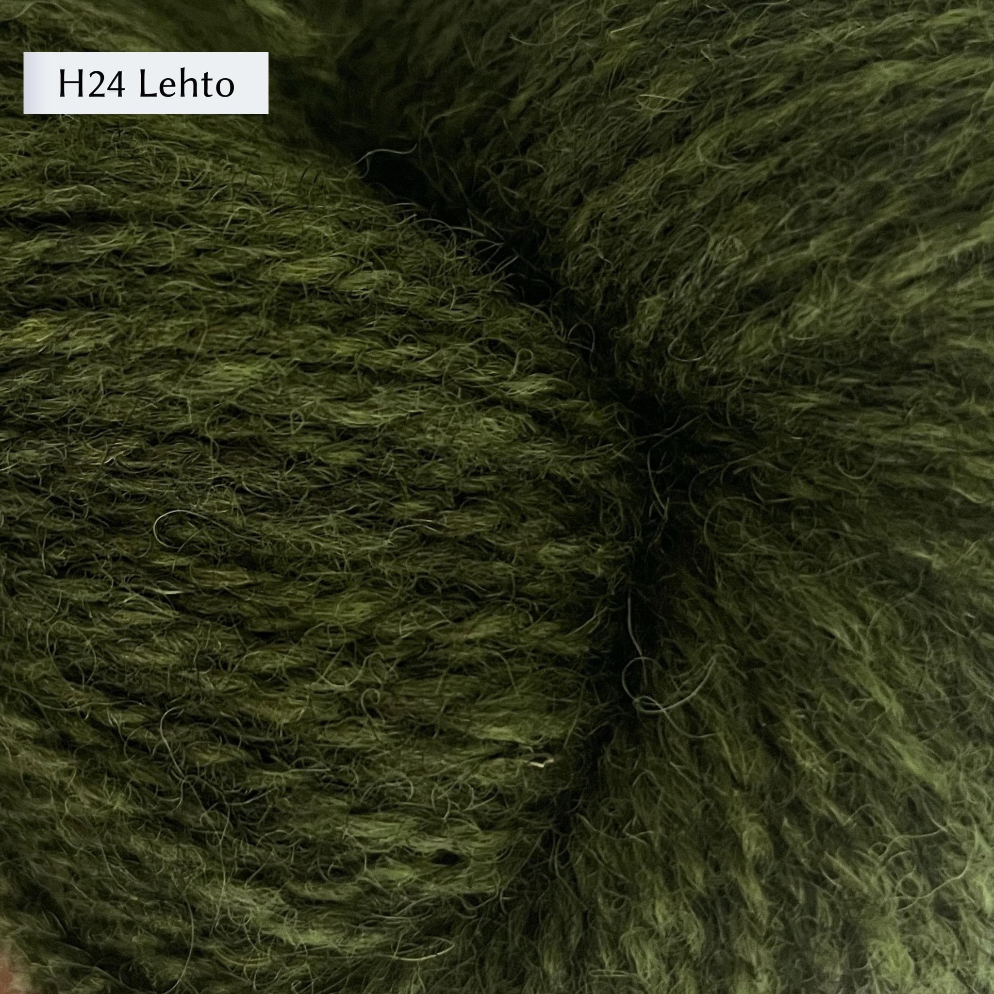 Tukuwool DK Yarn, 100% Finnish Wool shown in colorway H24 Lehto which is a heathered darker green color. 