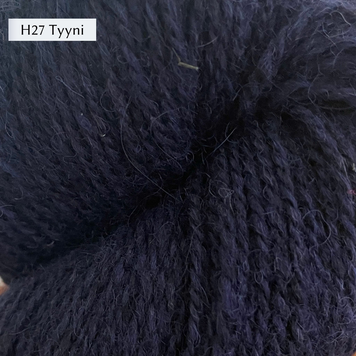 Tukuwool DK Yarn, 100% Finnish Wool shown in colorway H27 Tyyni which is a navy blue color. 