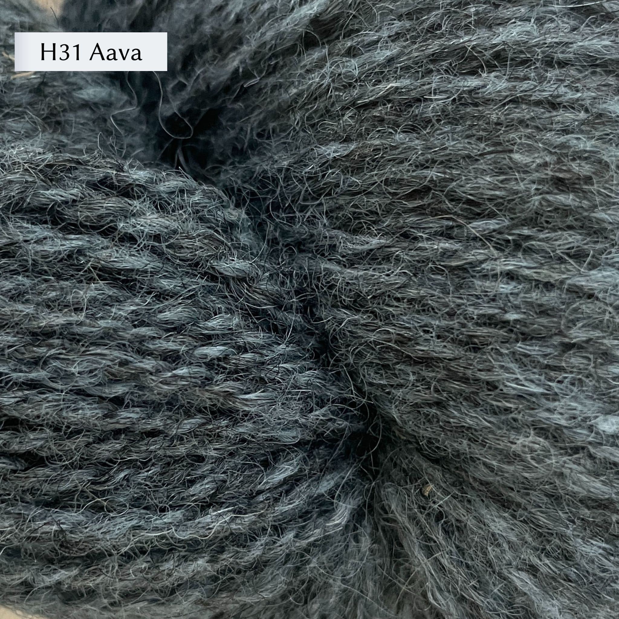 Tukuwool DK Yarn, 100% Finnish Wool shown in colorway H31 Aava which is a medium heathered blue color. 
