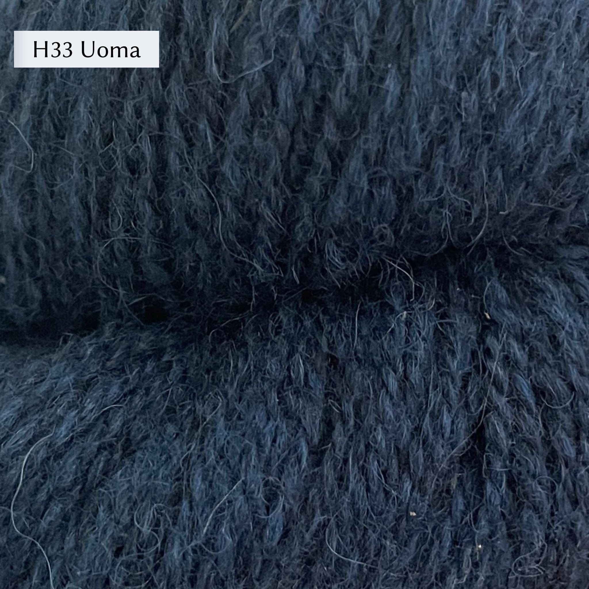 Tukuwool DK Yarn, 100% Finnish Wool shown in colorway H33 Uoma which is a heathered medium blue color. 