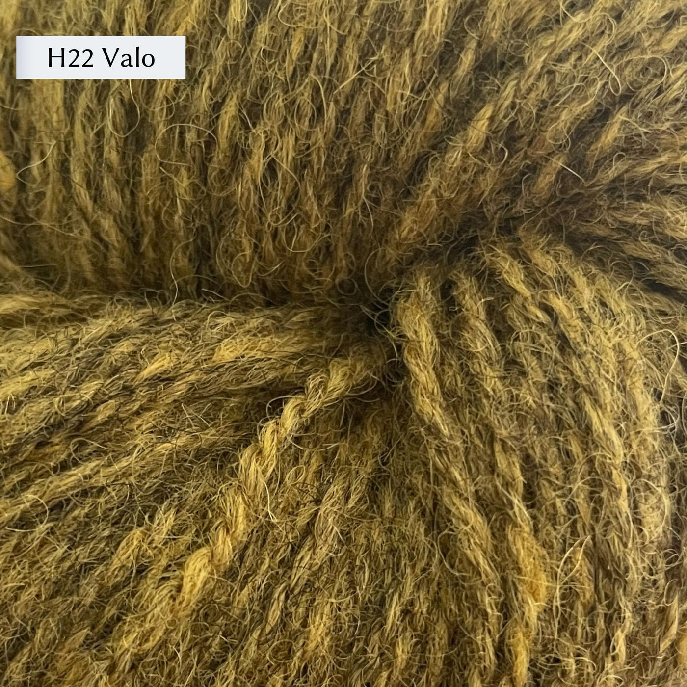 Tukuwool DK Yarn, 100% Finnish Wool shown in colorway H22 Valo which is a heathered green gold. color. 