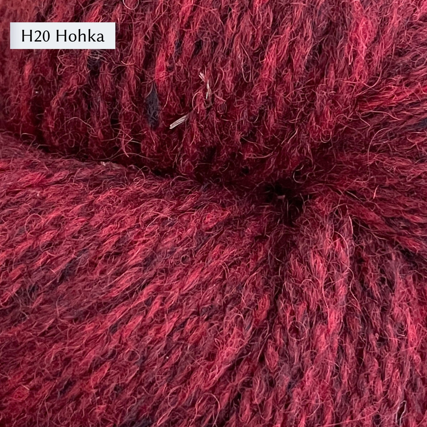 Tukuwool DK Yarn, 100% Finnish Wool shown in colorway H20 which is a heathered deep red. 