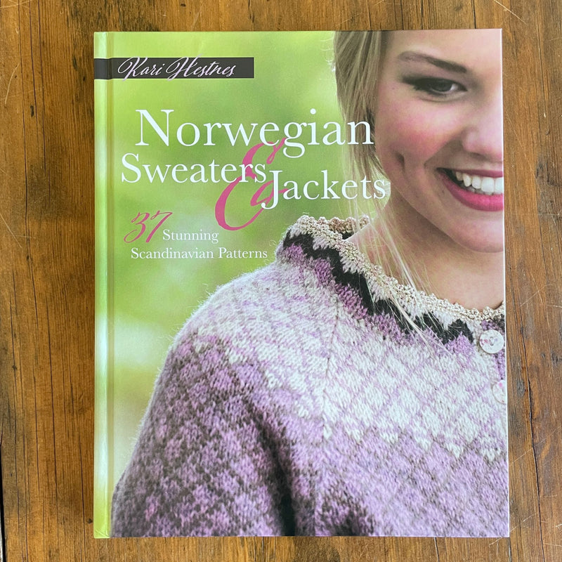 Cover of book Norwegian Sweaters & Jackets by Kari Hestnes shows woman wearing pink colorwork sweater.