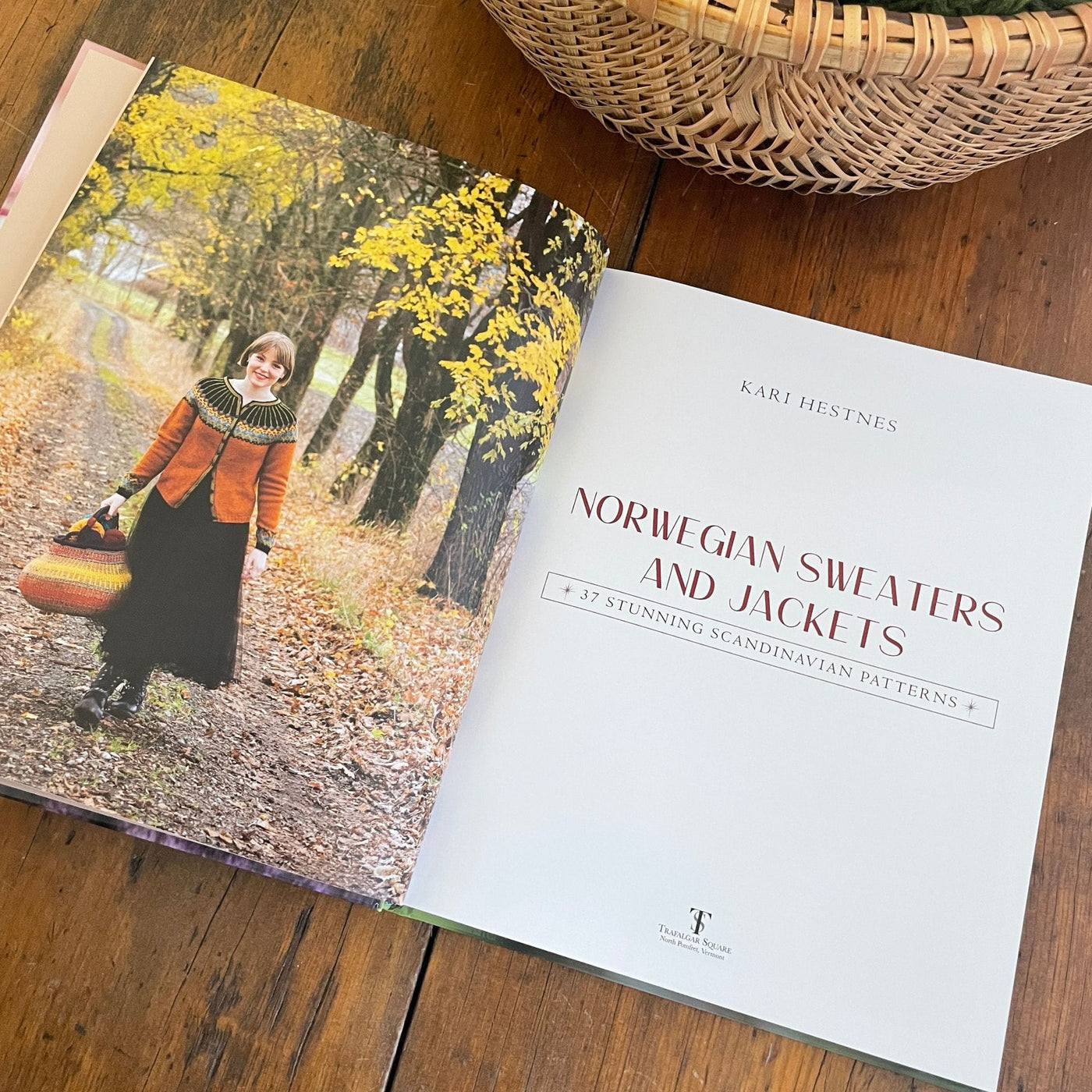 Inside pages of book Norwegian Sweaters & Jackets by Kari Hestnes shows woman wearing wearing colorwork yoke cardigan walking on nature path and title page opposite.