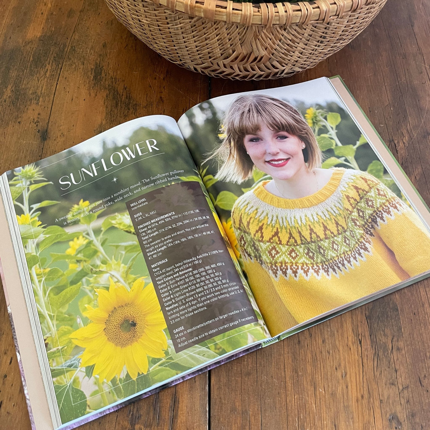 Inside pages of book Norwegian Sweaters & Jackets by Kari Hestnes shows woman wearing yellow colorwork sweater in Sunflower field.