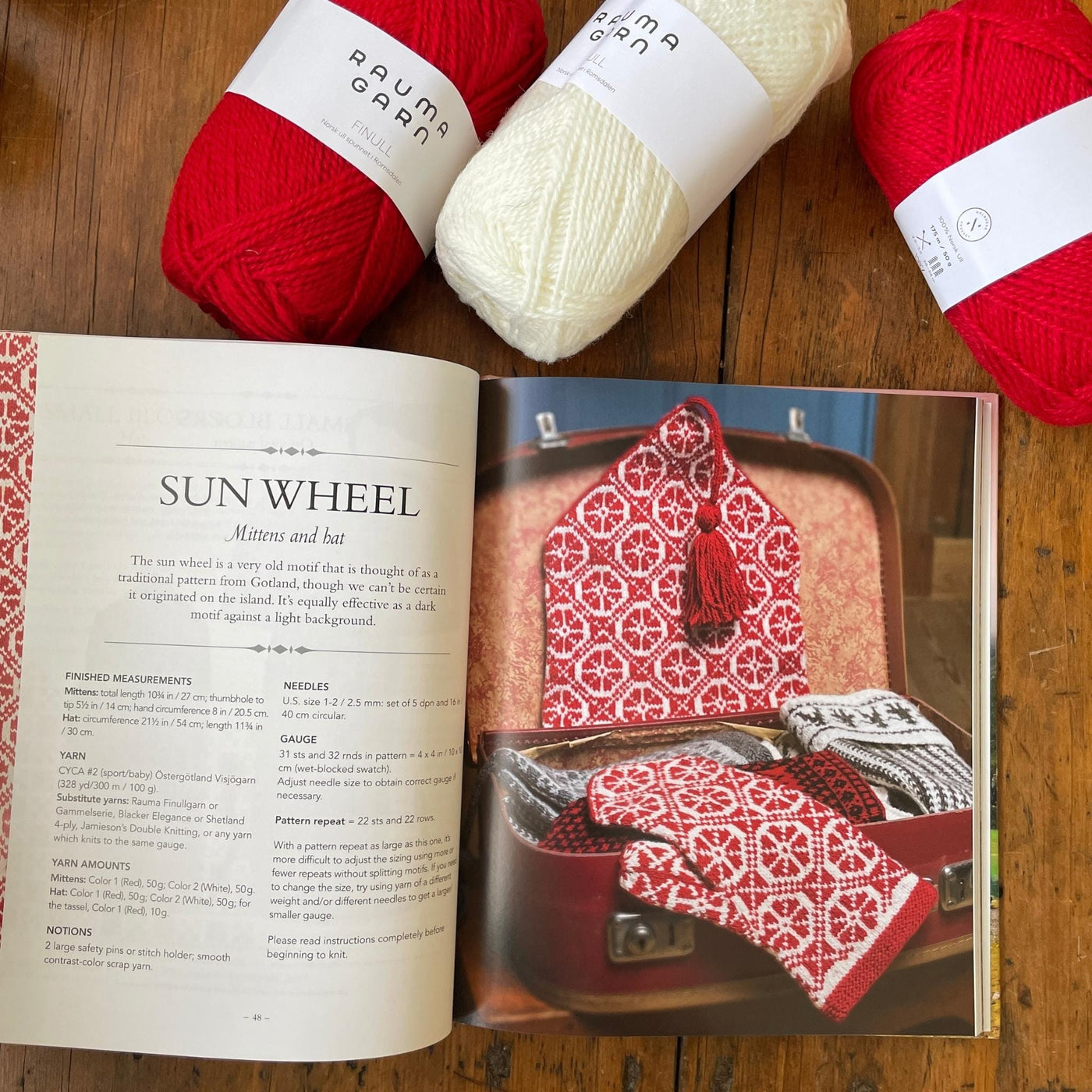 Page of Traditional Nordic Knits book with red and white colorwork mittens and hat with yarn beside book.