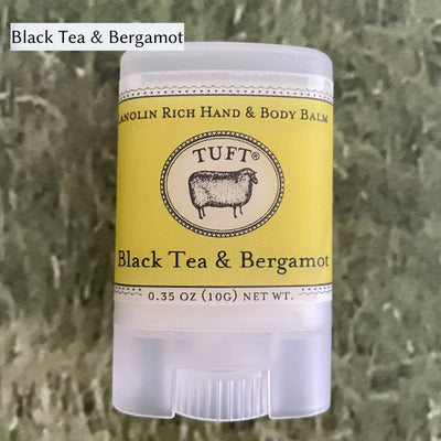 Container of Tufts Woolen Hand & Body Balm in scent called Black Tea & Bergamot. 