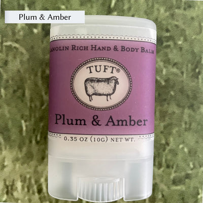 Container of Tufts Woolen Hand & Body Balm in scent called Plum & Amber. 