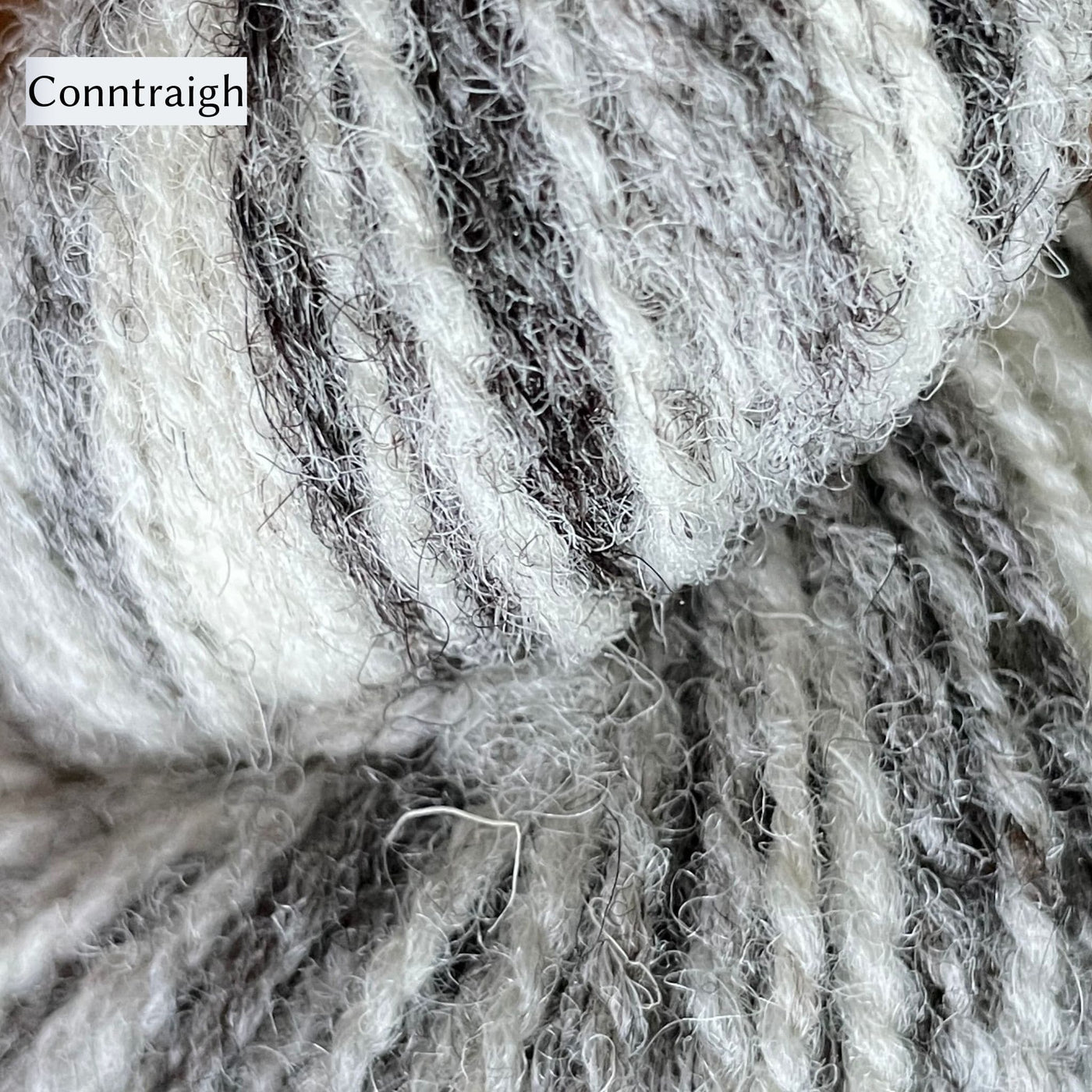UIST Wool DK weight shown in Conntraigh color which is a variegated yarn cream to grey colors.
