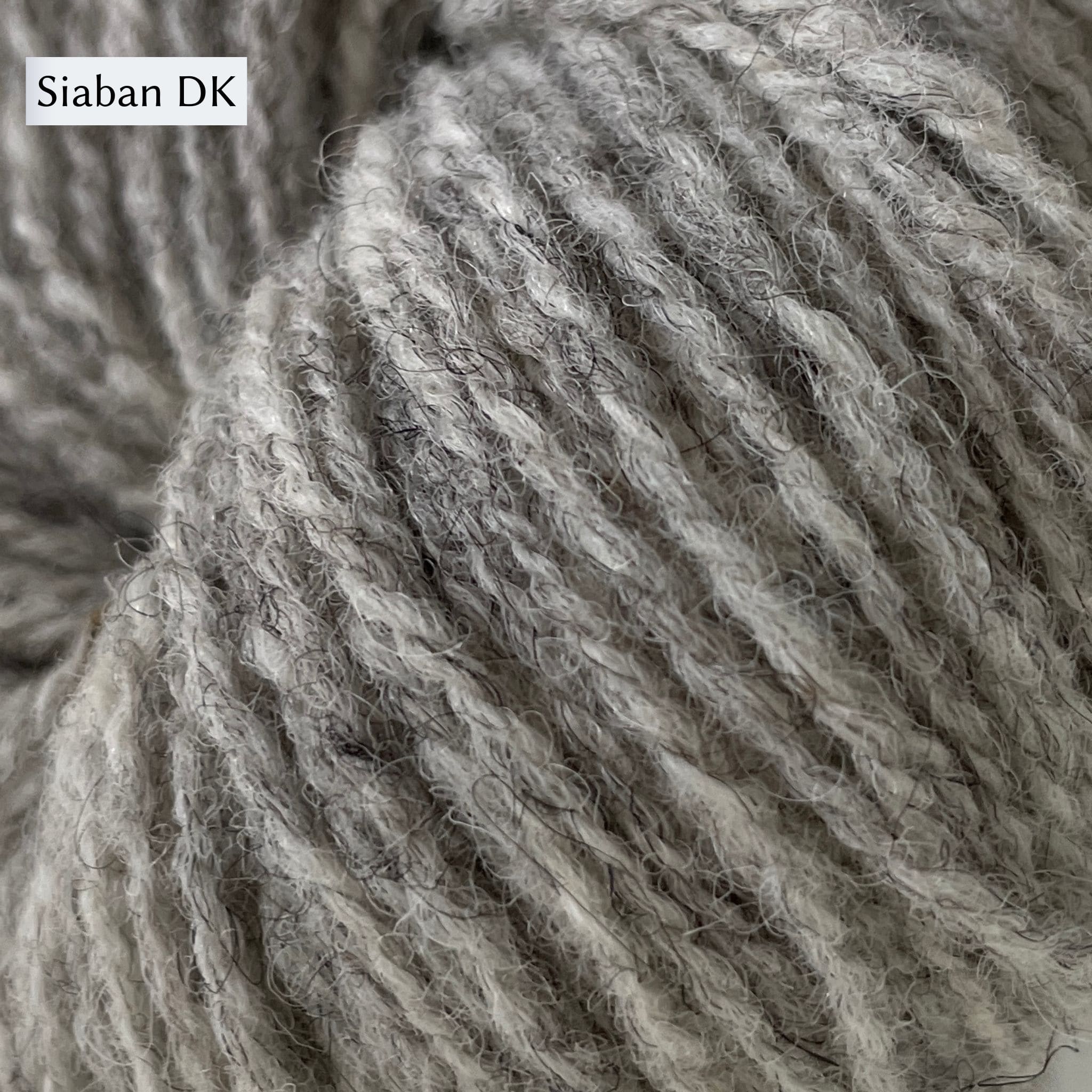UIST Wool DK weight shown in Siaban color which is a natural light grey.
