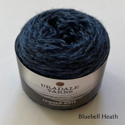 cake of Uradale DK  yarn in color Bluebell Heath- heathered blue