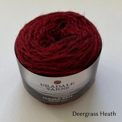 cake of Uradale DK yarn in color Deergrass Heath- heathered red