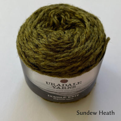 cake of Uradale yarn in color Sundew Heath- heathered green